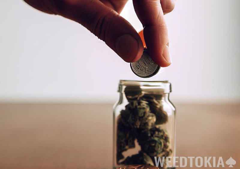 Coin being placed inside an empty pill bottle