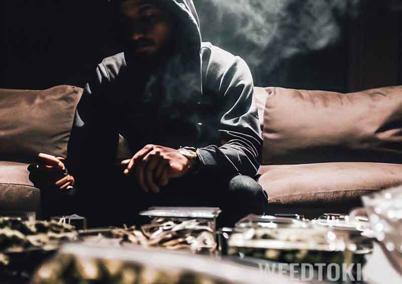 Guy smoking weed on his couch