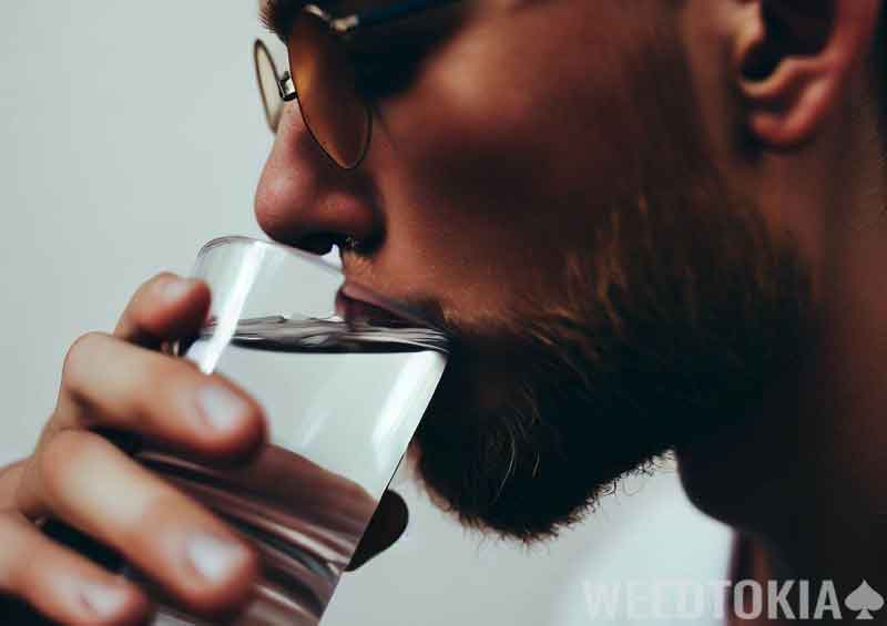 Hipster taking a sip of water