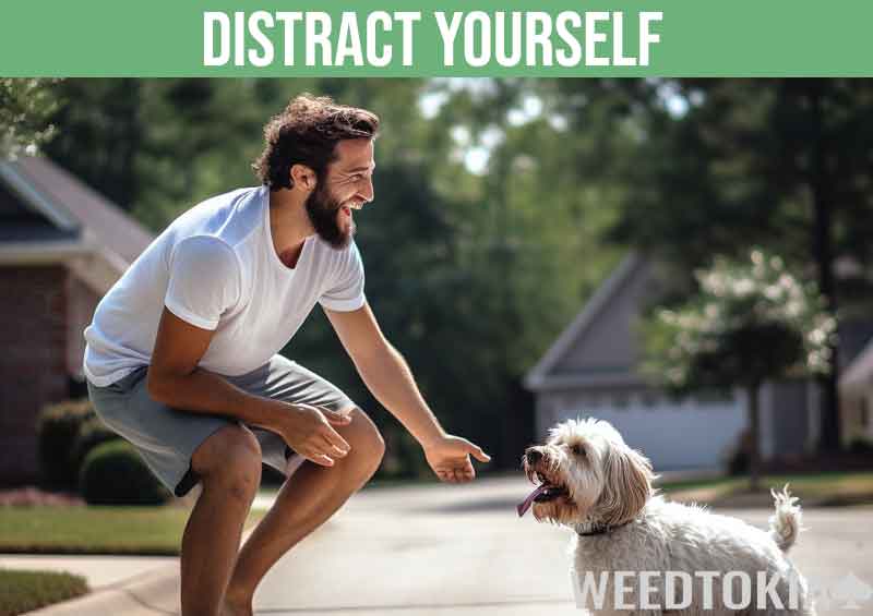 Guy playing with his dog in his driveway to avoid munchies