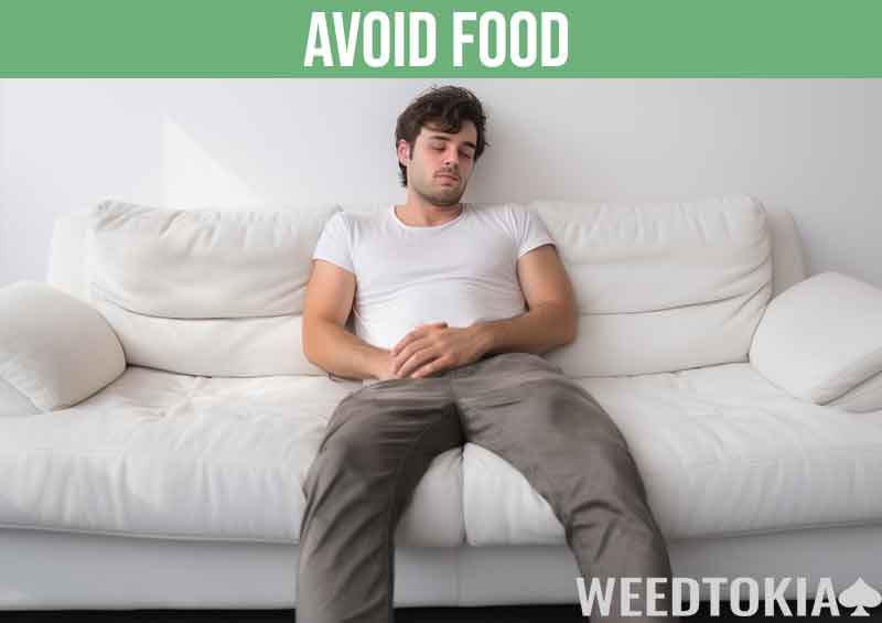 Hungry guy with munchies lying on his couch and fasting